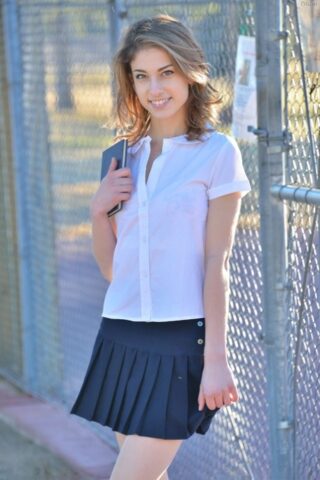 12569314_002_cbe5 Thin teen shows off her upskirt panties in her schoolgirl uniform on sidewalk