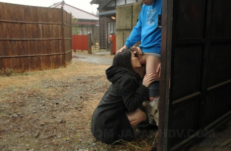 44328106_008_2761 Asian honey Mai Shimizu kneels in front of a guy and gives head outdoors