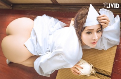Beautiful Asian girl strikes stunning poses showing her big boobs