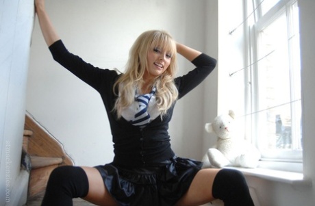47913247_005_4371 Adorable babe in black socks Elle Parker taking off her school uniform