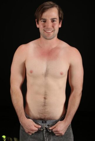 Good-looking gay Ethan shows off his athletic naked body and his hairy cock