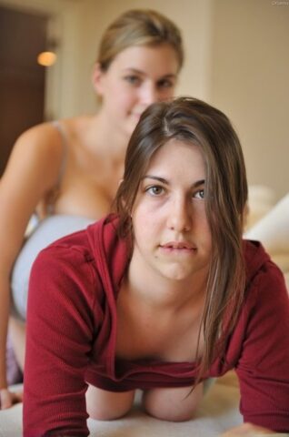 Brunette babe Orianna shows her swollen pussy and her friend her big tits