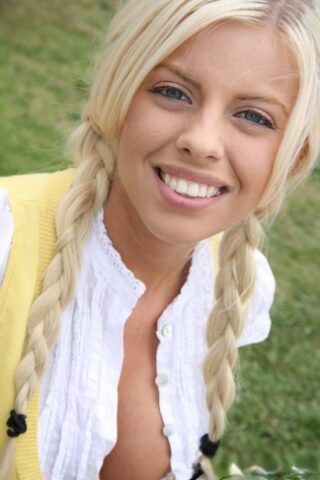 49078290_002_2e0a Teen with blue eyes & fake tits Britney Amber teases with her cleavage outside