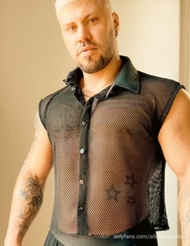Male bodybuilder with short blonde hair displays his chiseled torso
