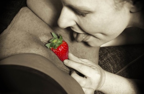 Amateur lesbians partake in foreplay with a blindfold and strawberries