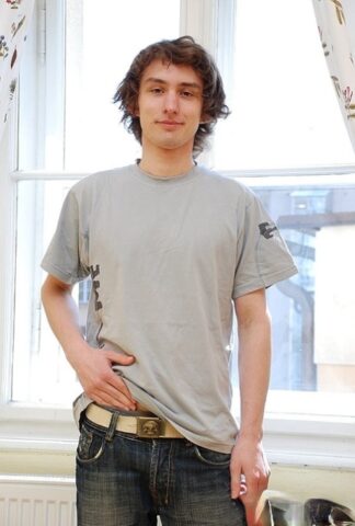 Brunette gay Robert Miller doffs his jeans and shirt and flaunts his boner