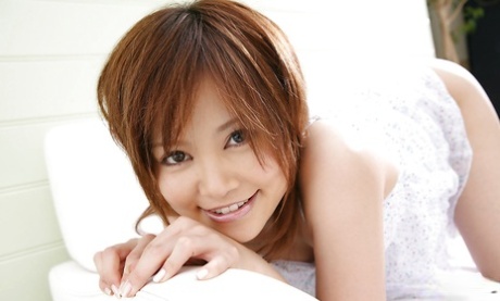 54536395_003_84f4 Tempting asian coed Hitomi Yoshino slipping off her lingerie