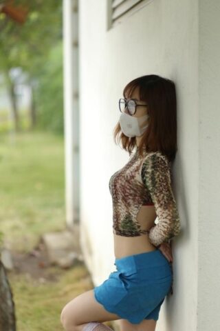 65527254_004_8331 Asian brunette babe with a mask & glasses poses in her sexy outfit