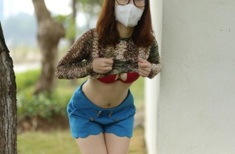 65527254_037_c4b3 Asian brunette babe with a mask & glasses poses in her sexy outfit