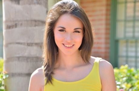 69339452_002_431b Gorgeous brunette teen strips out of her yellow dress in public