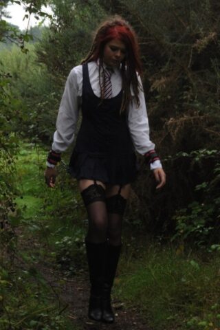 69801167_010_4e1b Tall schoolgirl shows off her hot legs in stockings and boots outdoors