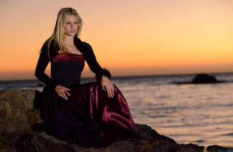 70745144_001_84d1 Blonde babe Scarlet Red goes topless during a sexy striptease at the beach