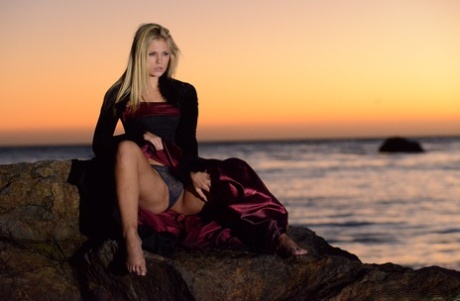 70745144_003_9b87 Blonde babe Scarlet Red goes topless during a sexy striptease at the beach
