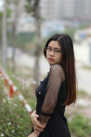 Pretty Asian model Natalia posing in her lovely black outfit outdoors