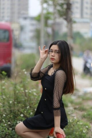 Pretty Asian model Natalia posing in her lovely black outfit outdoors