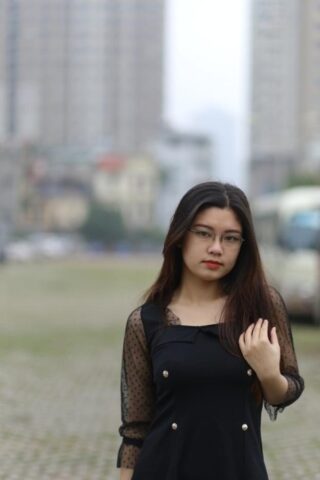 Pretty Asian model Natalia posing in her lovely black outfit outdoors