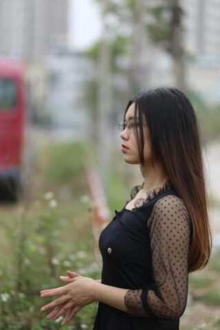 Pretty Asian model Natalia posing in her lovely black outfit outdoors
