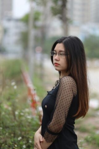 Pretty Asian model Natalia posing in her lovely black outfit outdoors