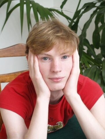 Blue eyed ginger twink Jackson C strips naked and jerks off his boner