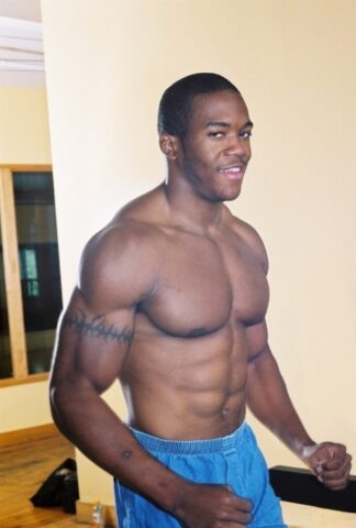 Black gay with hot muscles Houston A exposes his big prick after a gym workout