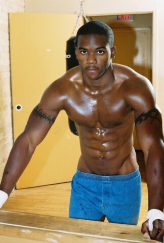 Black gay with hot muscles Houston A exposes his big prick after a gym workout