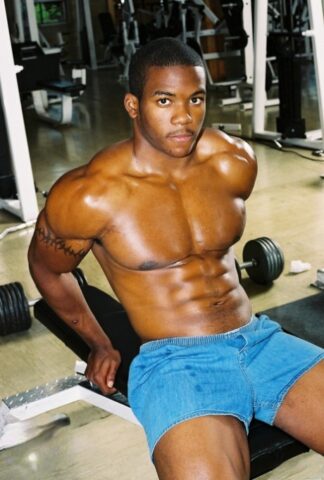 Black gay with hot muscles Houston A exposes his big prick after a gym workout