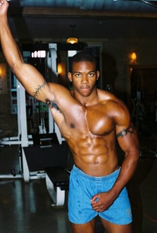 Black gay with hot muscles Houston A exposes his big prick after a gym workout