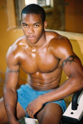 Black gay with hot muscles Houston A exposes his big prick after a gym workout