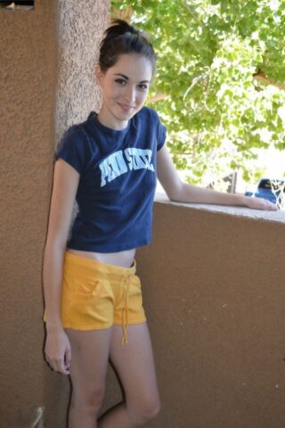 86951539_002_8a72 Petite amateur babe teases with her big ass in yellow shorts on the balcony