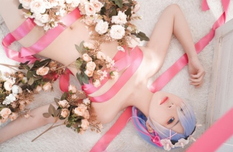 96184833_005_af77 Beautiful Asian model with big tits poses while wrapped in pink satin ribbon