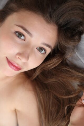 Lovely Ukrainian babe Mila Azul teases with her beautiful big tits on her bed