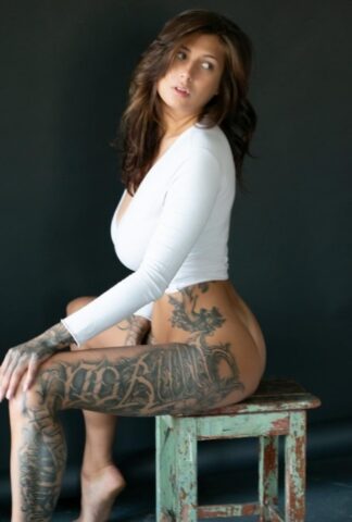 71239132_036_462e Tattooed chick poses in her underthings as well as nude albeit in a SFW manner